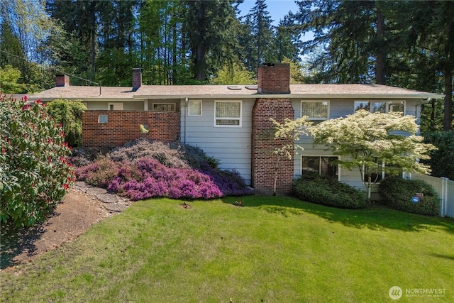 2139 SW 316th St, Federal Way, WA 98023 - back of house featuring a lawn, fence, and a chimney