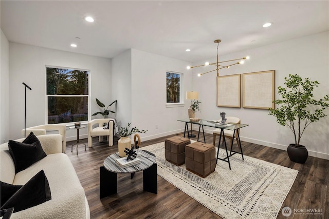 living room with recessed lighting, dark wood-type flooring, baseboards, and an inviting chandelier