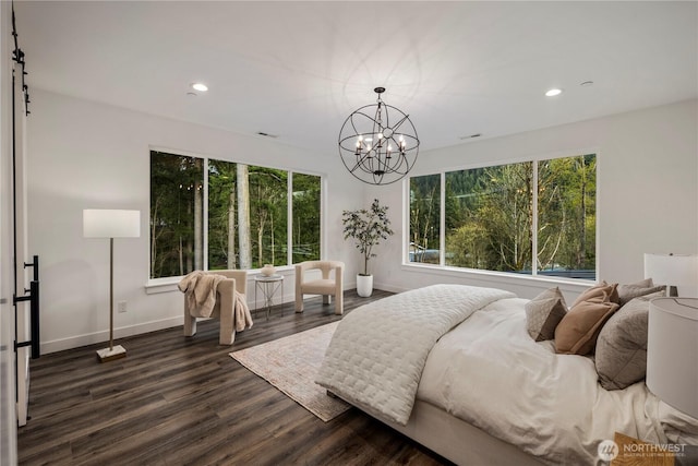 bedroom featuring baseboards, multiple windows, and an inviting chandelier