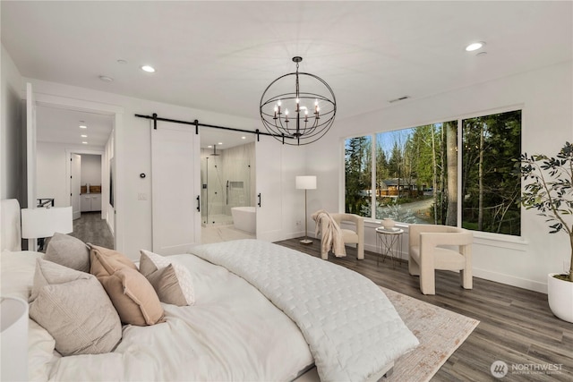 bedroom with recessed lighting, baseboards, an inviting chandelier, and a barn door