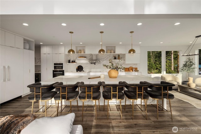 kitchen featuring dark wood-type flooring, decorative backsplash, recessed lighting, and wall oven