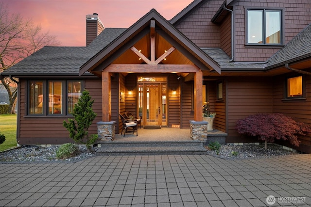 3193 Northshore Rd, Bellingham, WA 98226 - property entrance with a porch, decorative driveway, a chimney, and a shingled roof
