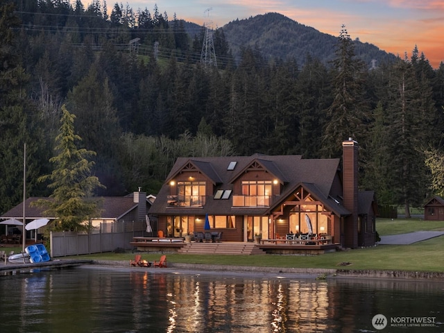 3193 Northshore Rd, Bellingham, WA 98226 - rear view of house featuring a lawn, a water and mountain view, a chimney, and a forest view