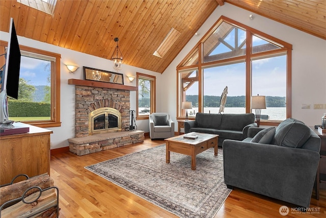 3193 Northshore Rd, Bellingham, WA 98226 - living room with a water view, a skylight, wood finished floors, and a fireplace