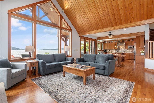 3193 Northshore Rd, Bellingham, WA 98226 - living room with ceiling fan, high vaulted ceiling, light wood-type flooring, a water view, and beamed ceiling