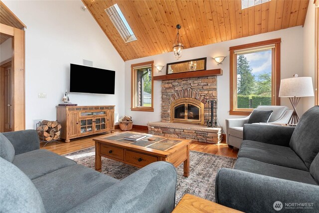 3193 Northshore Rd, Bellingham, WA 98226 - living room with wood ceiling, a stone fireplace, wood finished floors, and vaulted ceiling with skylight