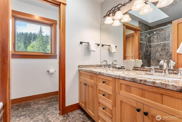3193 Northshore Rd, Bellingham, WA 98226 - full bathroom featuring double vanity, baseboards, tiled shower, and a sink