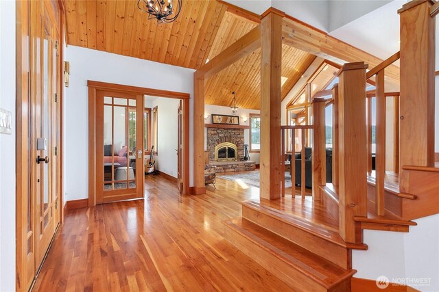 3193 Northshore Rd, Bellingham, WA 98226 - interior space with french doors, wood finished floors, baseboards, a chandelier, and vaulted ceiling with beams