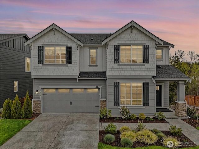 18619 128th St E, Bonney Lake, WA 98391 - view of front of property featuring driveway, a garage, a shingled roof, and stone siding