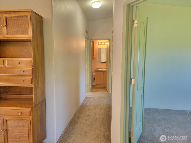 hall with light colored carpet