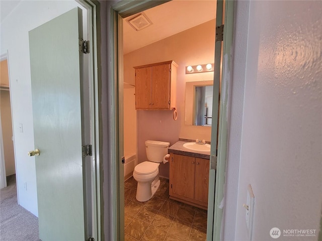 bathroom featuring visible vents, toilet, vanity, and a shower
