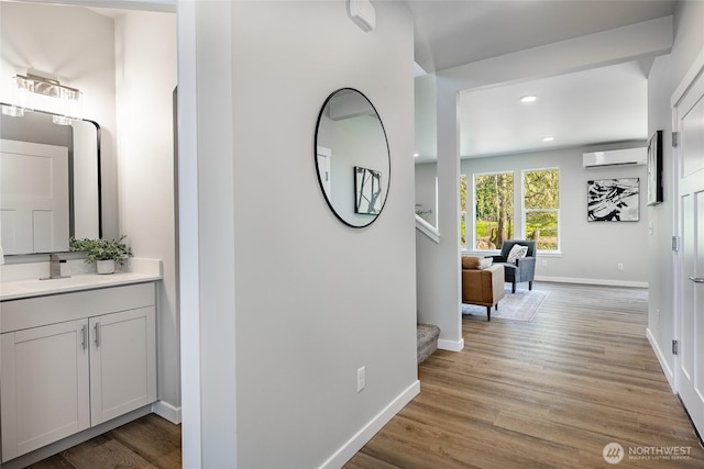 3009 Oleander Ln, Blaine, WA 98230 - corridor with a sink, a wall mounted air conditioner, light wood-style flooring, recessed lighting, and baseboards