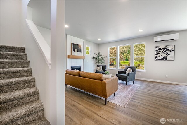 3009 Oleander Ln, Blaine, WA 98230 - living area with wood finished floors, stairs, plenty of natural light, and a wall unit AC