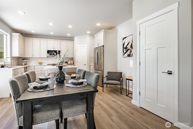 3009 Oleander Ln, Blaine, WA 98230 - dining space featuring baseboards, recessed lighting, and light wood-type flooring