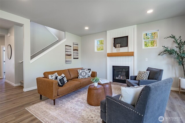 3009 Oleander Ln, Blaine, WA 98230 - living area featuring wood finished floors, a fireplace, baseboards, stairway, and recessed lighting