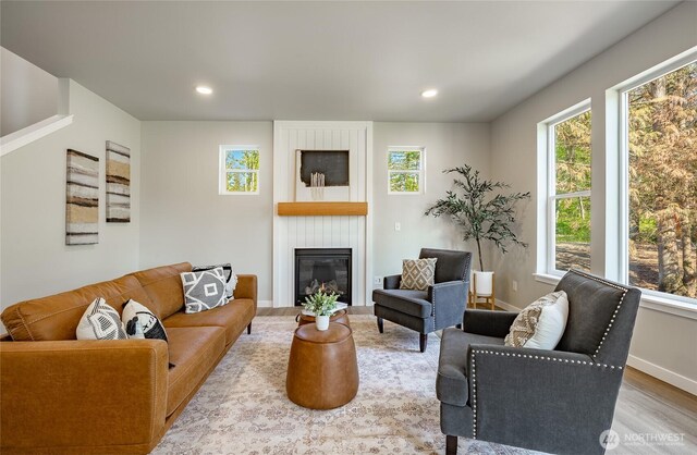 3009 Oleander Ln, Blaine, WA 98230 - living area featuring a large fireplace, recessed lighting, baseboards, and wood finished floors
