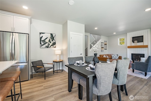 3009 Oleander Ln, Blaine, WA 98230 - dining area featuring stairs, recessed lighting, a large fireplace, and light wood finished floors