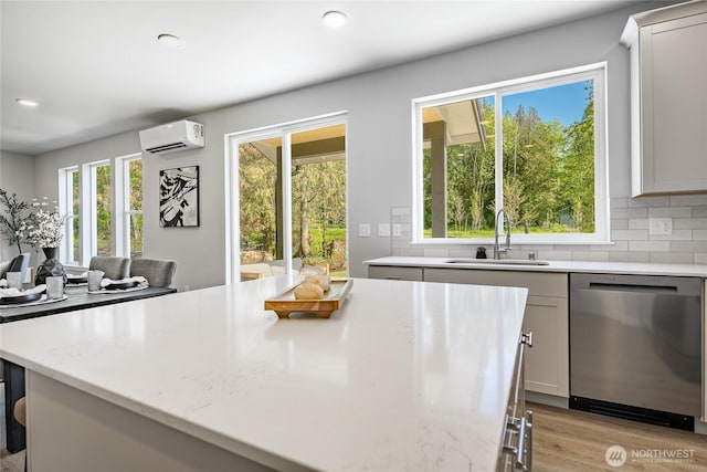 3009 Oleander Ln, Blaine, WA 98230 - kitchen with a sink, an AC wall unit, a wealth of natural light, and dishwasher