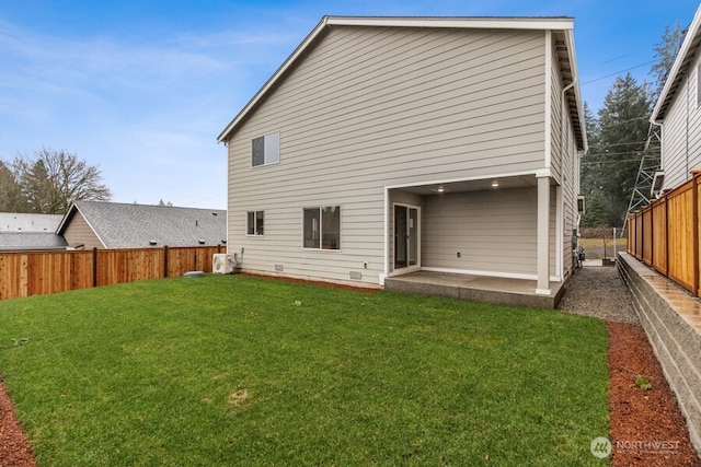 back of property featuring a patio, a yard, and a fenced backyard