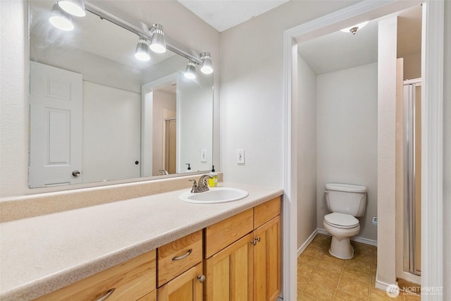 1555 Union Ave NE Unit 27, Renton, WA 98059 - full bathroom with a stall shower, toilet, vanity, baseboards, and tile patterned flooring