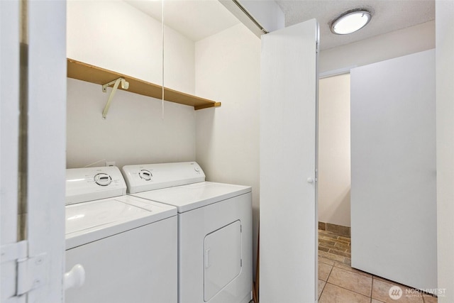 1555 Union Ave NE Unit 27, Renton, WA 98059 - clothes washing area with washer and clothes dryer and light tile patterned floors
