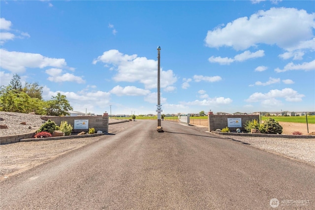 view of road with a gated entry and a gate