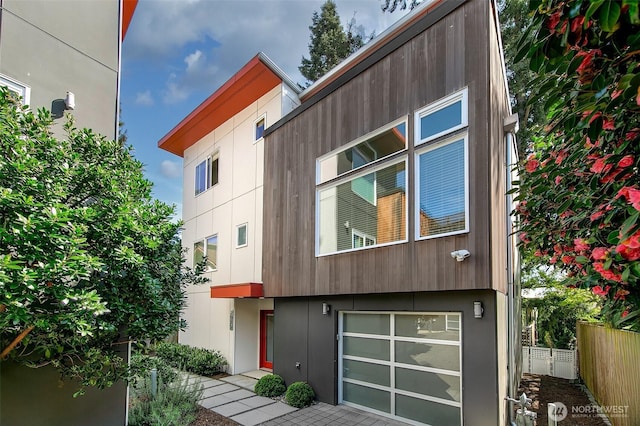 exterior space with fence and a garage