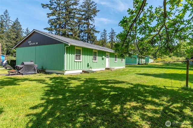 exterior space featuring a lawn and board and batten siding