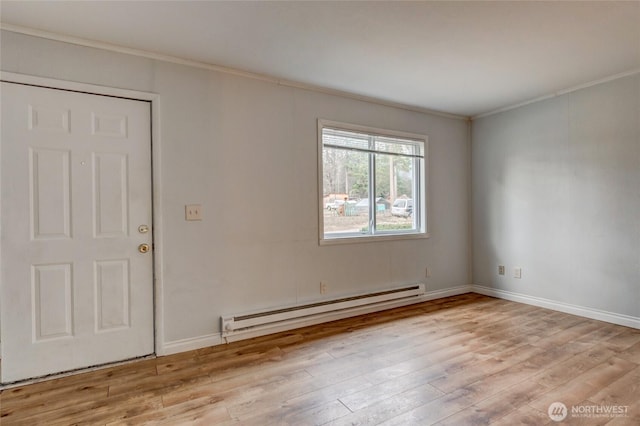 unfurnished room featuring crown molding, baseboards, a baseboard heating unit, and wood finished floors