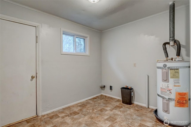 clothes washing area with crown molding, strapped water heater, and baseboards