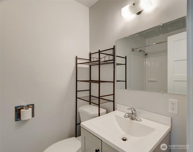 full bath featuring vanity, walk in shower, and toilet