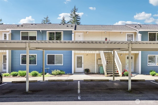 multi unit property featuring stairway and covered parking
