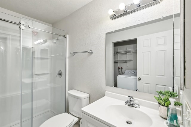 full bath with a stall shower, a textured wall, toilet, and washer / dryer
