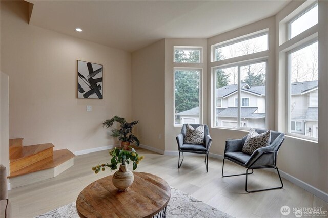 12446 NE 7th Pl, Bellevue, WA 98005 - living area with light wood-style flooring, baseboards, and a healthy amount of sunlight