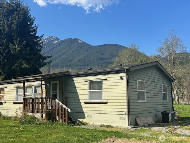 rear view of house featuring crawl space and a mountain view