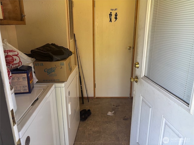 laundry area with cabinet space, tile patterned floors, and washer and dryer