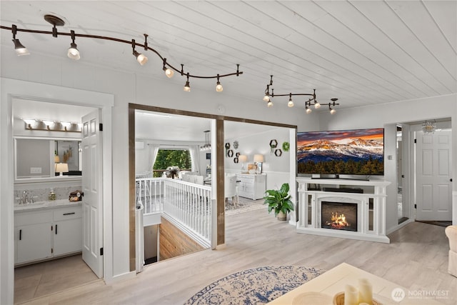living area featuring wood finished floors and a warm lit fireplace