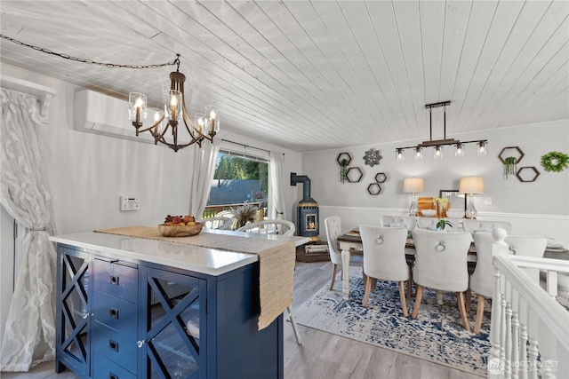 kitchen featuring blue cabinets, wood ceiling, a chandelier, light wood finished floors, and light countertops