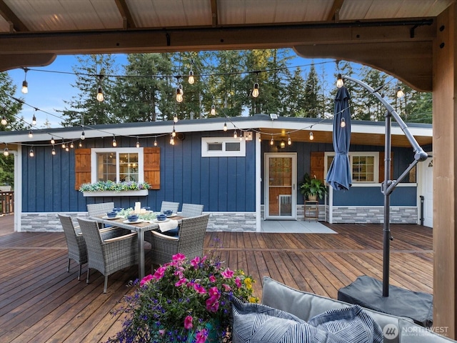 deck with outdoor dining area