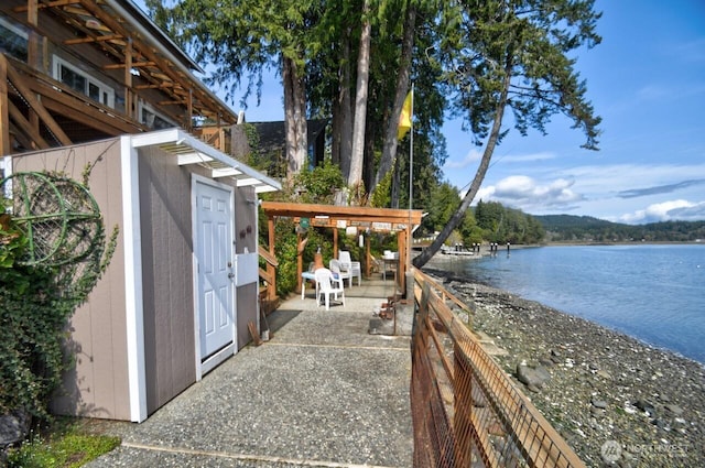 exterior space with a water view and an outdoor structure