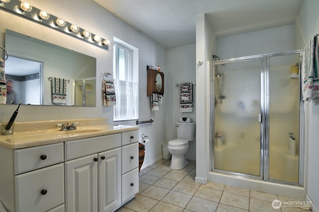 full bath featuring tile patterned floors, toilet, a shower stall, and vanity