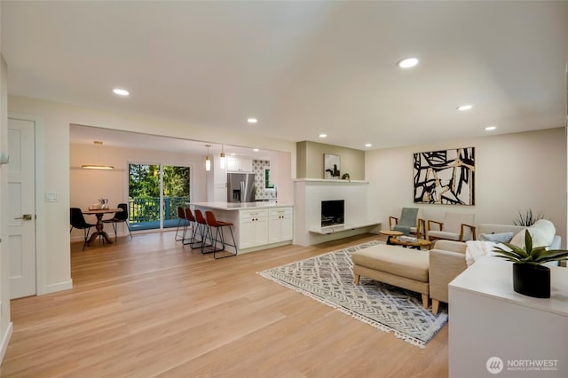 19010 12th Ave NE, Shoreline, WA 98155 - living area featuring light wood-type flooring, recessed lighting, and a fireplace with raised hearth