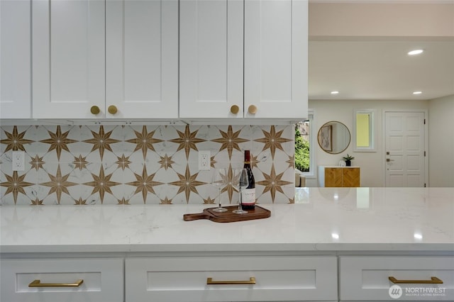 19010 12th Ave NE, Shoreline, WA 98155 - detailed view of white cabinetry, light stone counters, decorative backsplash, and recessed lighting
