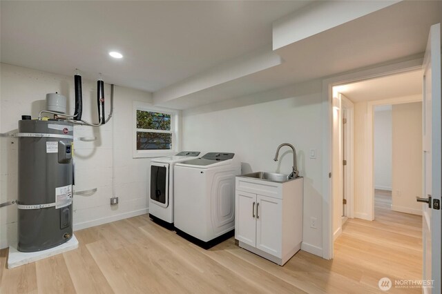 19010 12th Ave NE, Shoreline, WA 98155 - laundry area featuring washer and clothes dryer, water heater, light wood-style flooring, cabinet space, and recessed lighting