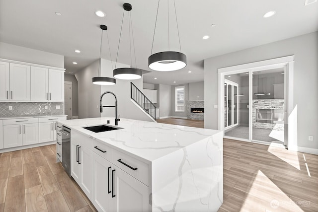 1436 238th St SE, Bothell, WA 98021 - kitchen with backsplash, a sink, and light wood finished floors