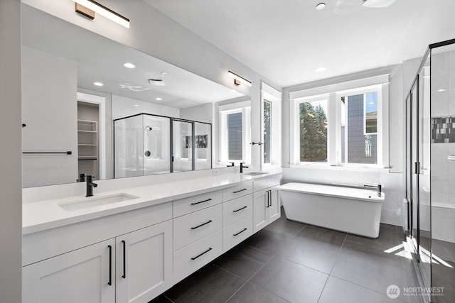 1436 238th St SE, Bothell, WA 98021 - bathroom featuring double vanity, recessed lighting, a soaking tub, a sink, and a shower stall