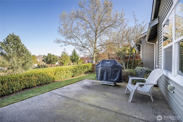 view of patio with area for grilling and fence