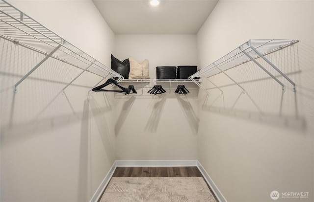 spacious closet with wood finished floors