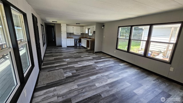 411 W Grove St Unit B, Shelton, WA 98584 - unfurnished living room featuring dark wood finished floors, baseboards, and a sink