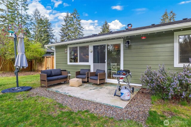 rear view of property featuring a yard, a patio, fence, and outdoor lounge area